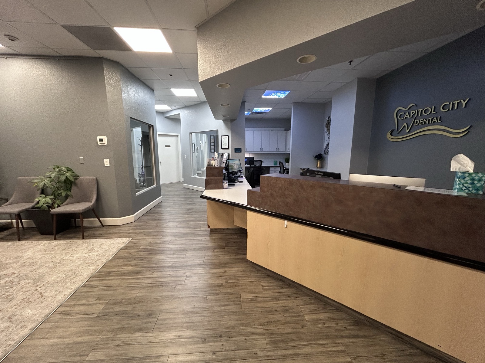 Clean dental office reception area with polished floors, organized desk, and spotless waiting room in Sacramento